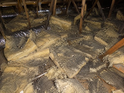 Old, dust-damaged ceiling insulation batts before removal in a Melbourne roof space